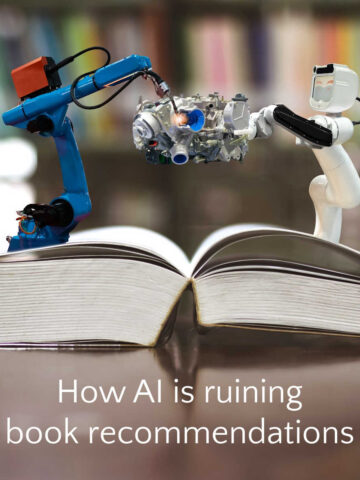 Two robots standing on an open book fighting over a piece of technology.