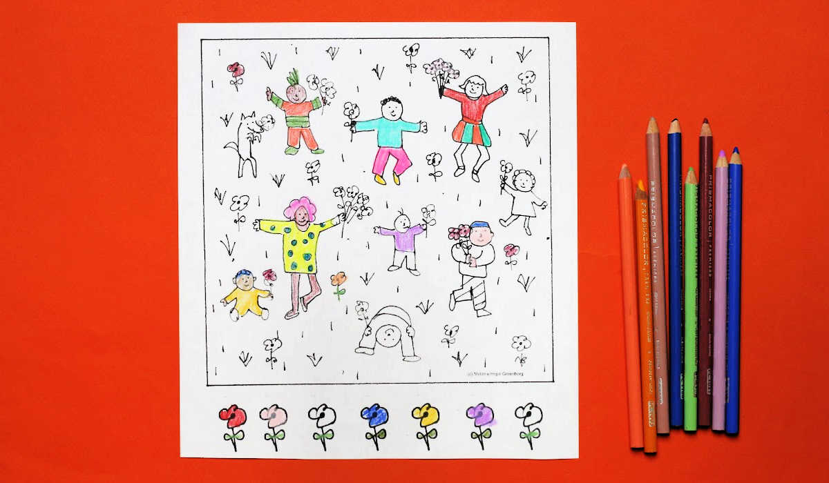 Coloring page with dancing children among flowers, partially colored in, next to several colored pencils.