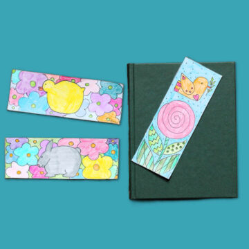 Three colorful spring themed bookmarks featuring flowers, bird, chick and bunny, next to a book.