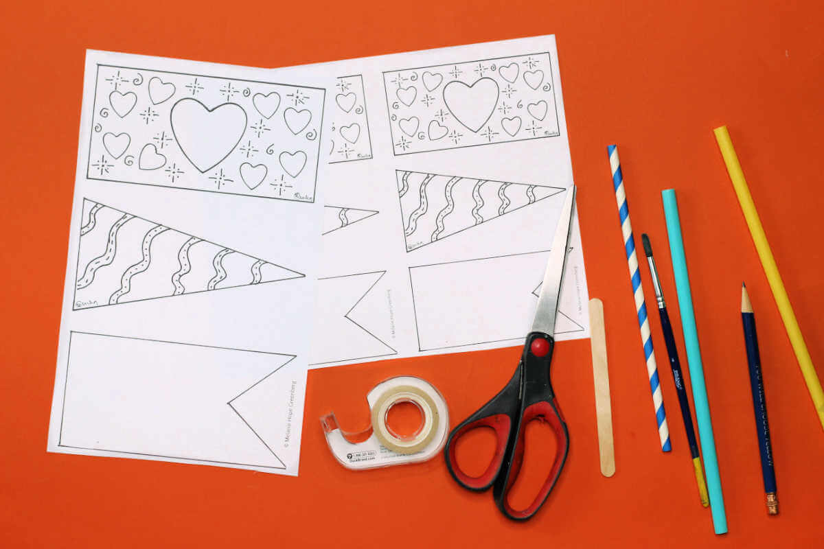Two sheets of flag design coloring pages, scissors, tape, straws, sticks and pencils.